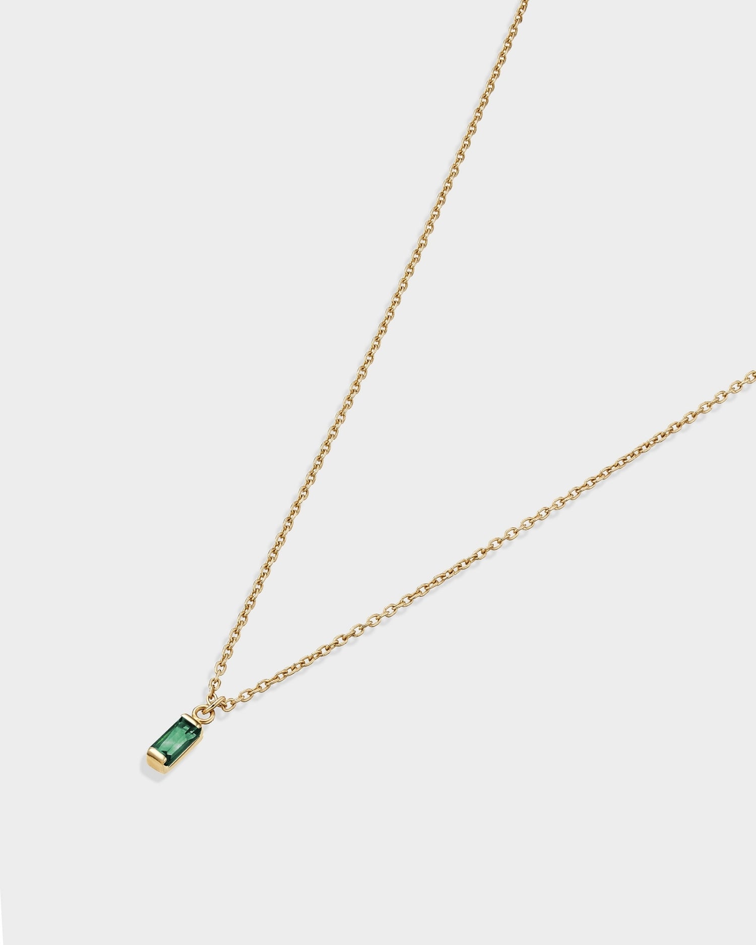 Baguette 14k gold necklace with emerald gemstone
