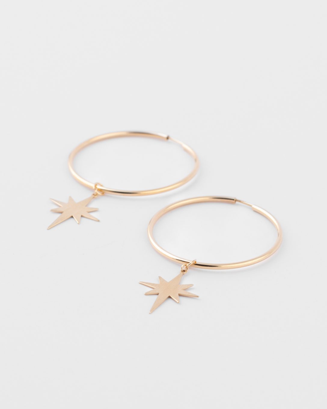 Large yellow gold star hoop earrings