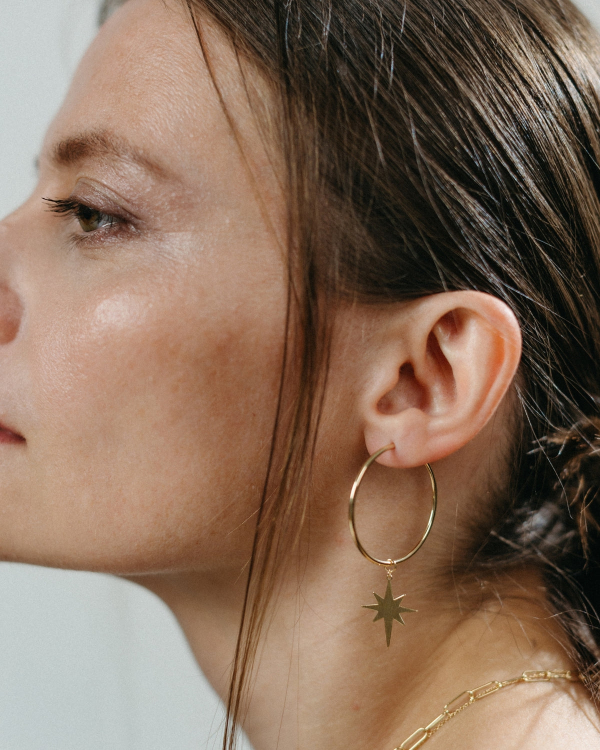 Large yellow gold star hoop earrings