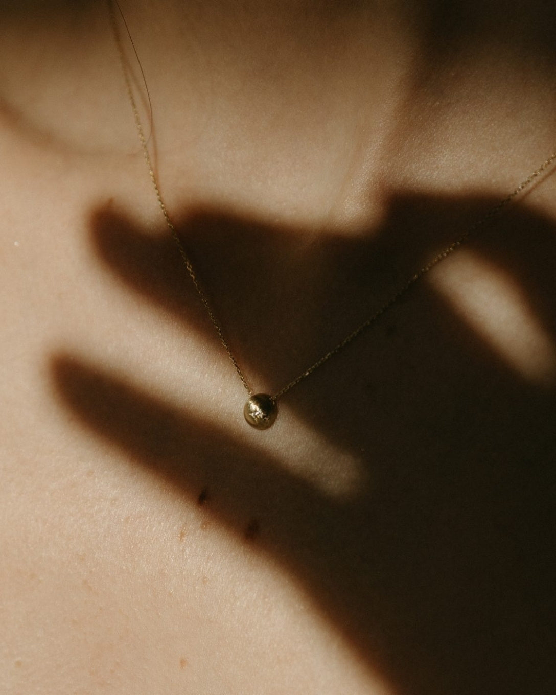 Yellow gold diamond globe necklace