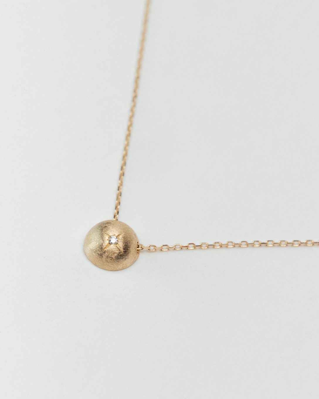 Yellow gold diamond globe necklace